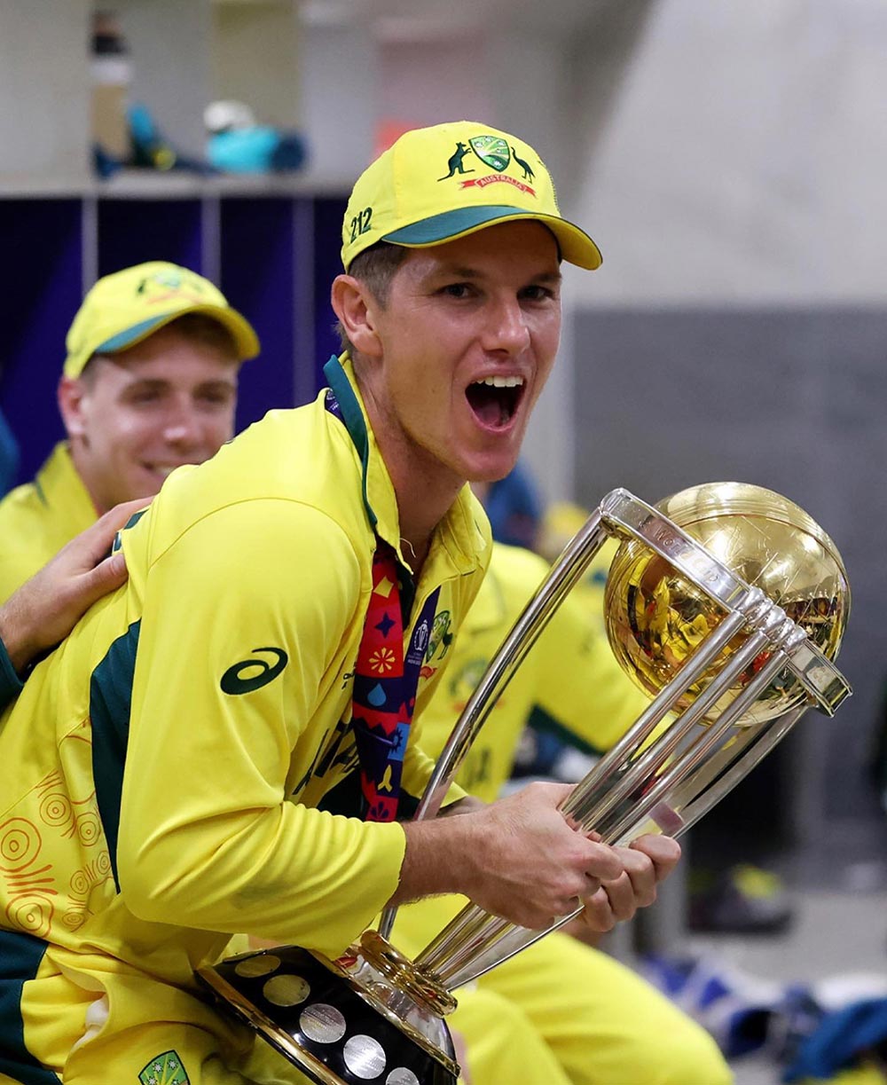 Adam Zampa holds a world cup.