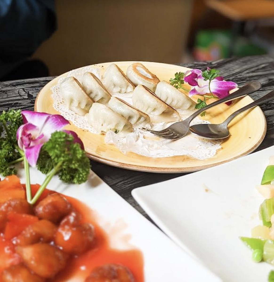 A plate of dumplings and sweet and sour pork - all vegan