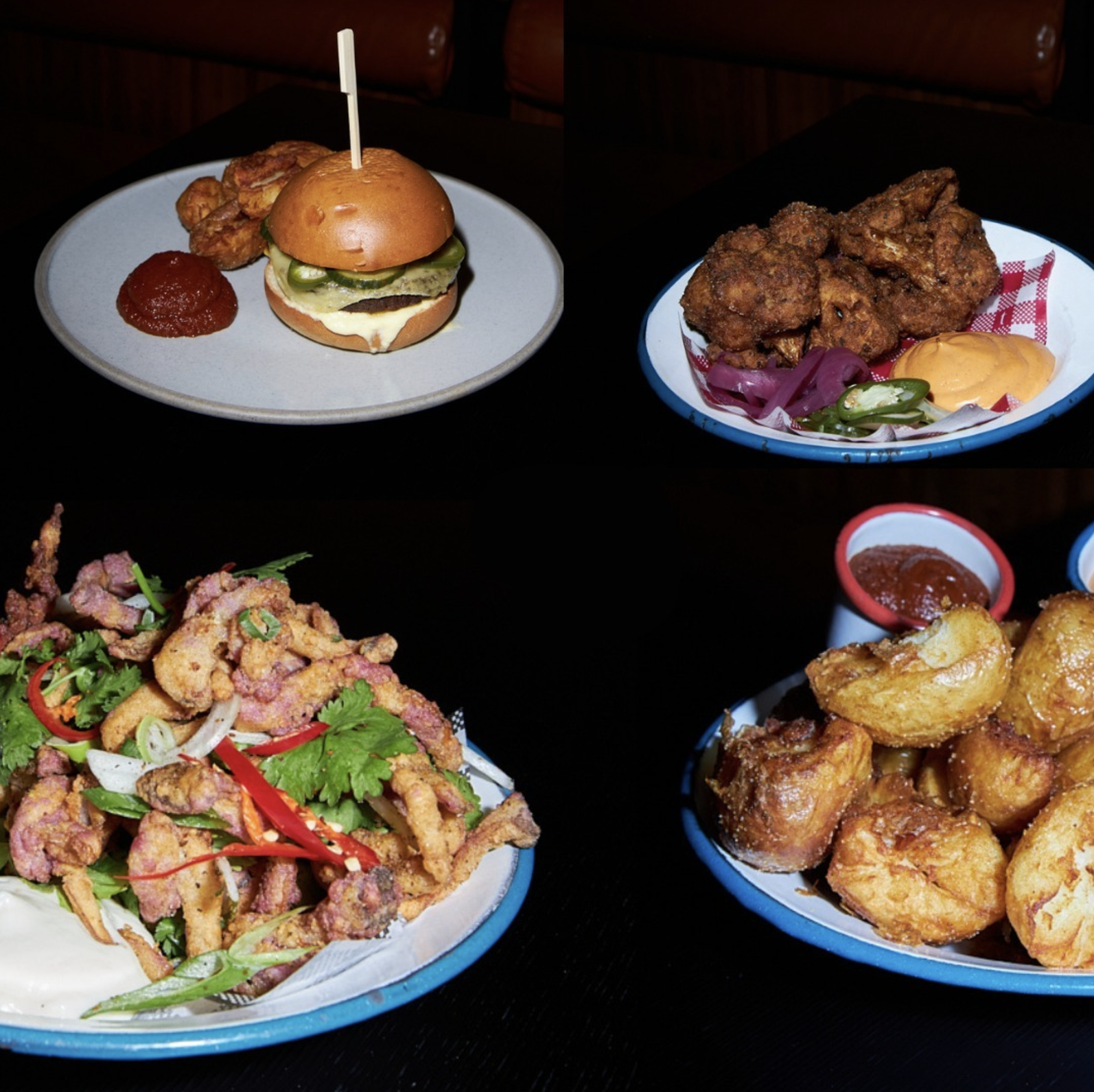  A spread of delicious vegan pub food including calamari, a cheese burger, and more.