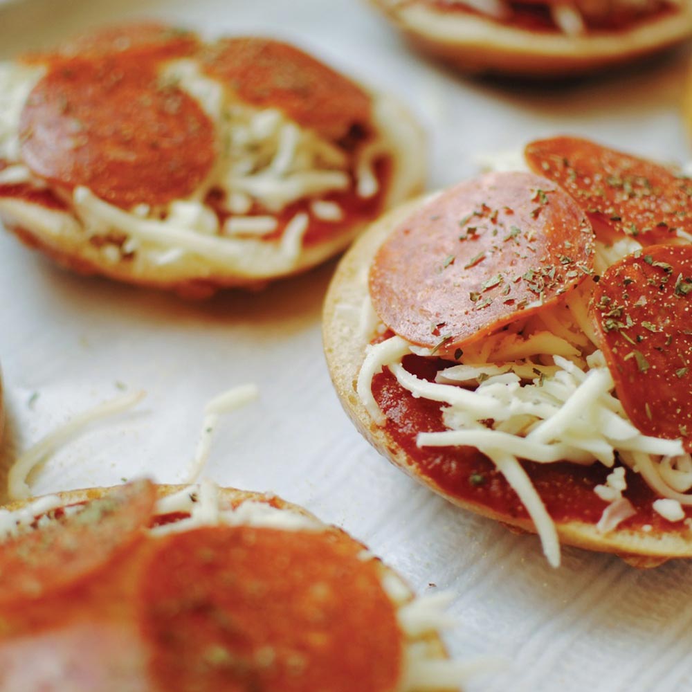 Mini pizza rounds topped with tomato sauce, cheese, and Made with Plants plant-based pepperoni slices.