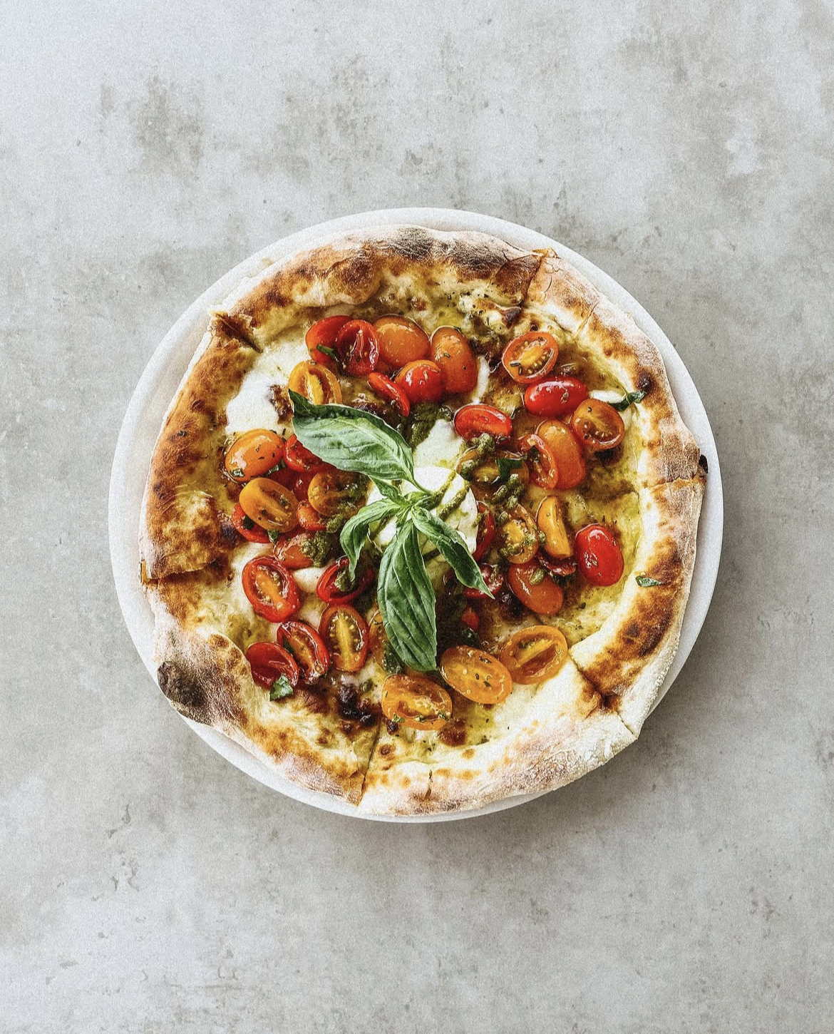 A delicious cherry tomato and pesto pizza from vegan-friendly Brisbane restaurant Antica Pizzaria