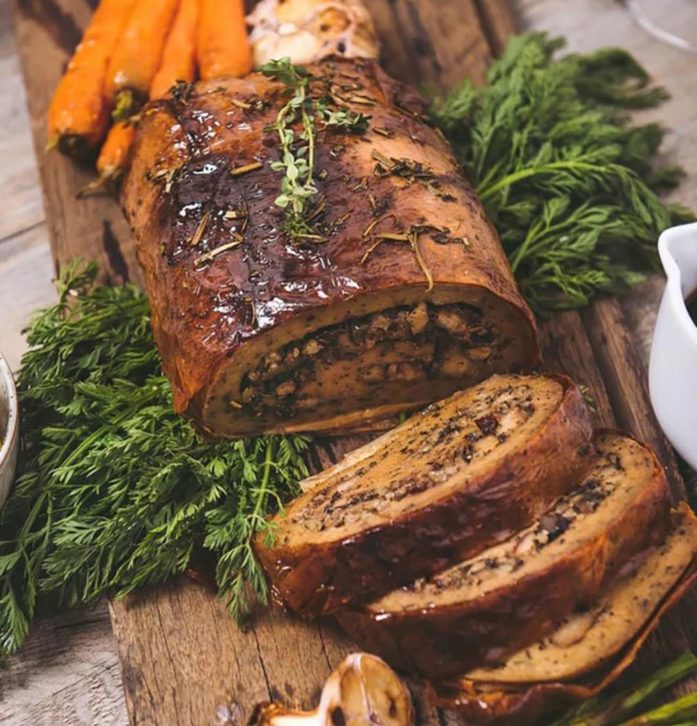 An image of a vegan roast cut to reveal the stuffing centre.