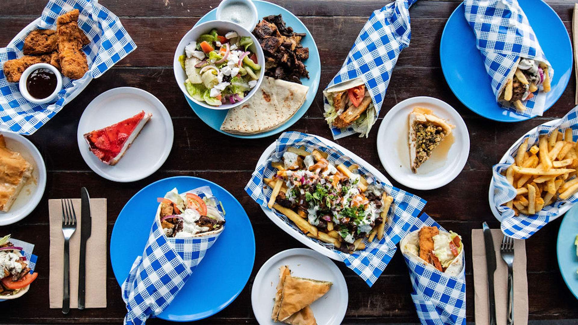 A spread of Mina Maria's vegan greek food on a table.