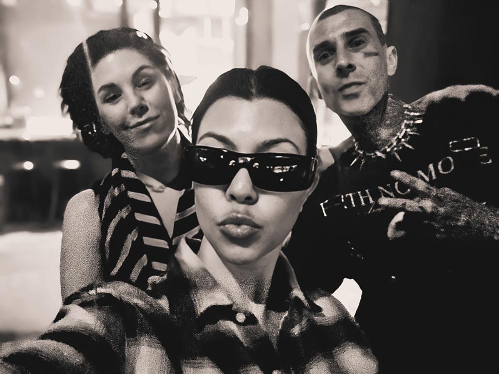 Kourtney Kardashian takes a selfie with Shannon Martinez to the left and Travis Barker to the right.