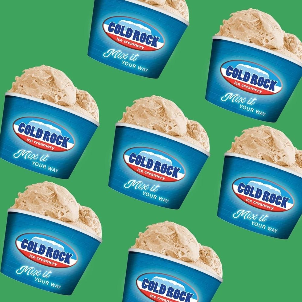 A repeat pattern of cups of Cold Rock's vegan cinnamon donut ice cream on a green background.