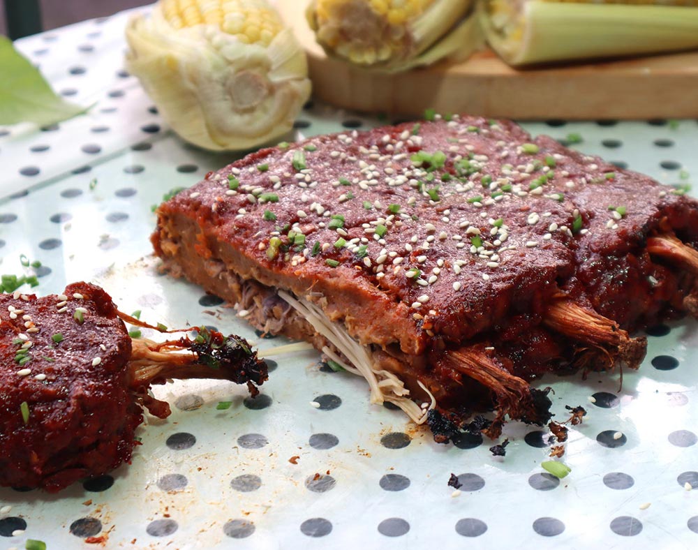 BBQ-style ribs made from seitan with enoki mushroom bones.