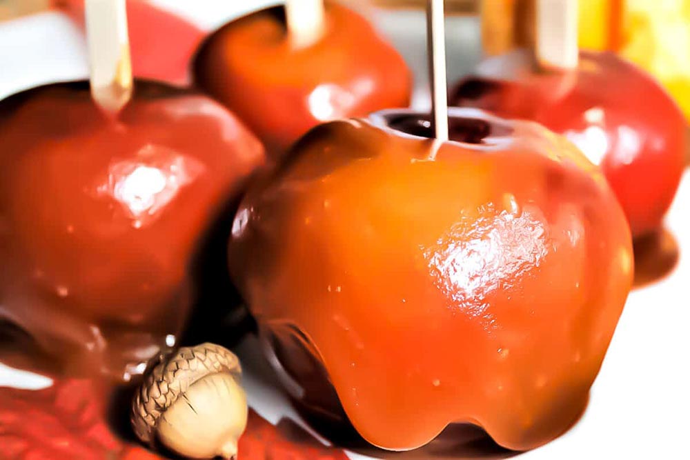 Upturned apples on sticks are coated with a thick and delicious chewy caramel.