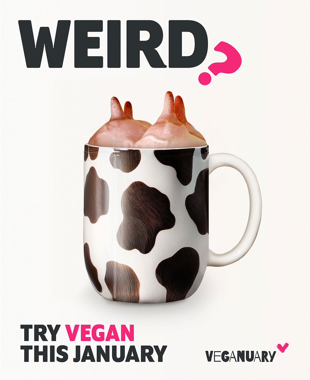 A cow print patterned mug with an udder protruding out of it. 