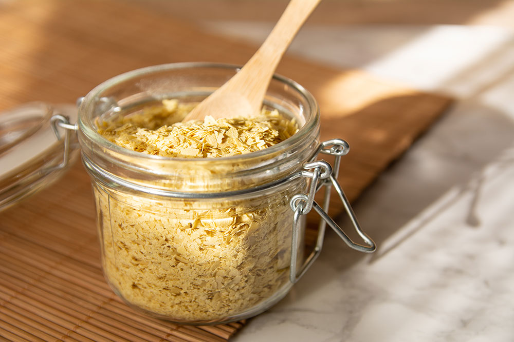 A glass jar full of nutritional yeast.