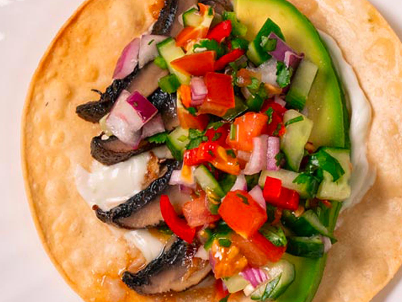 Close up of a Garlic Mushroom Tostada with Avocado Salsa