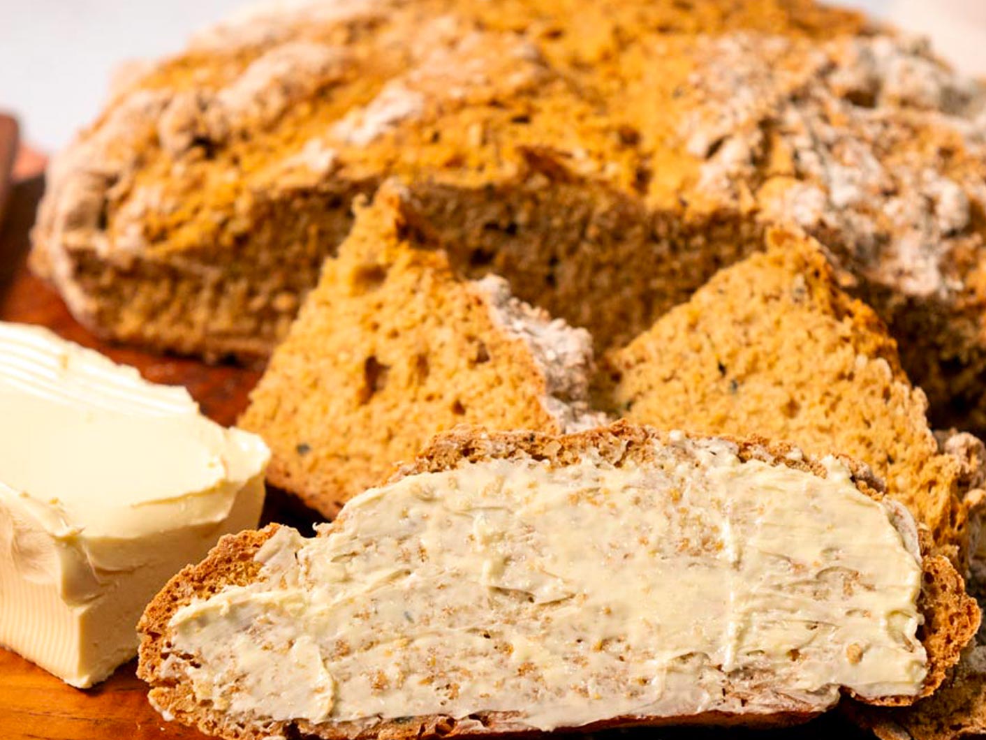 A close up of the slices of Irish Soda Bread slathered with vegan butter.