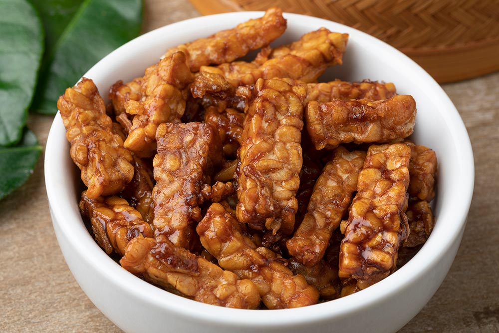 A bowl of marinated tempeh.