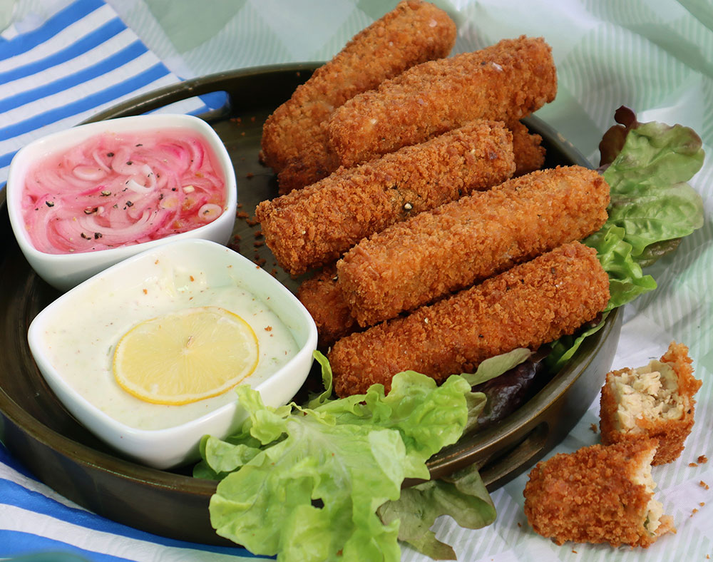 Fried and crumbed tempeh 'fish' fingers with tartare sauce.