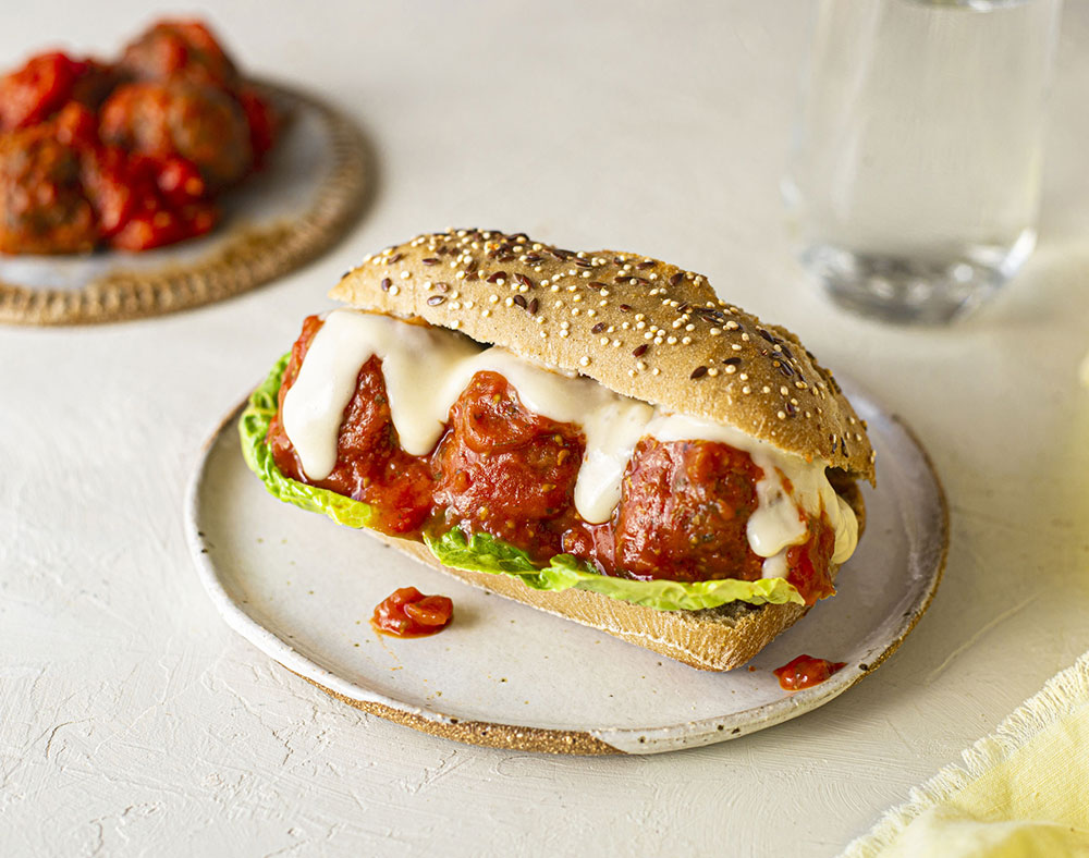 An eggplant and tempeh 'meatball' sub on a seeded bun.