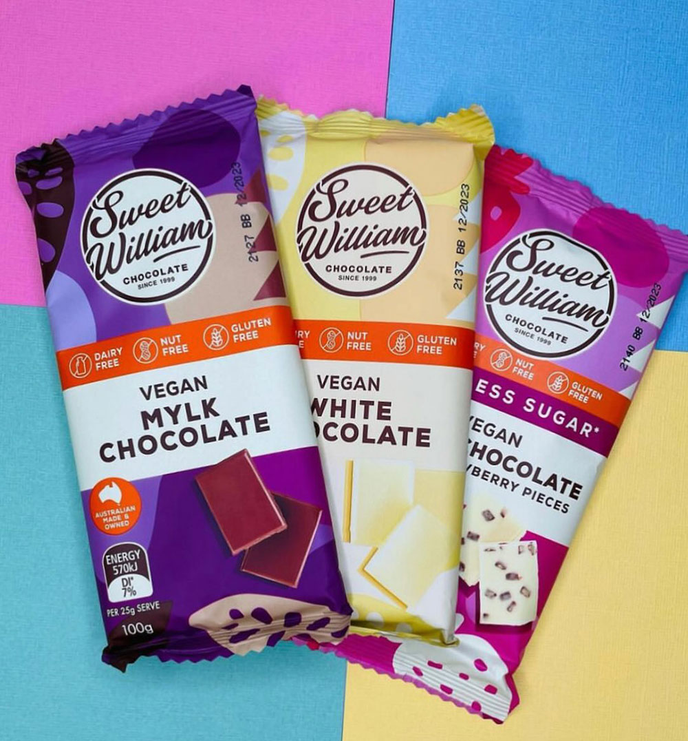 Three varieties of the Sweet William chocolate block range on a geometric pastel background.