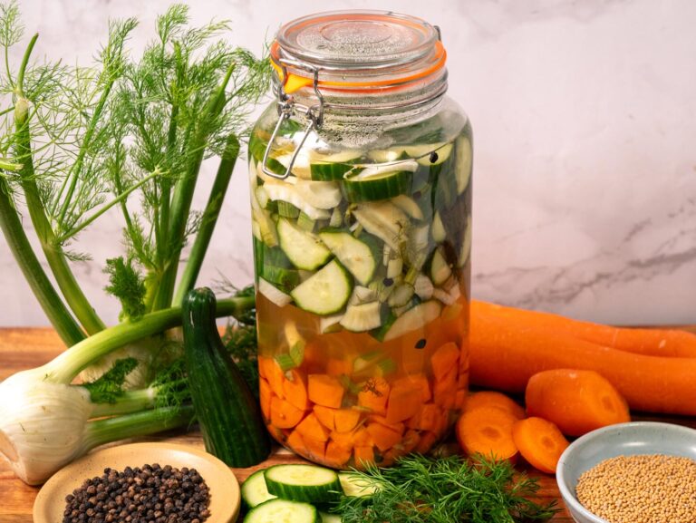 A jar of pickled vegetables in brine.