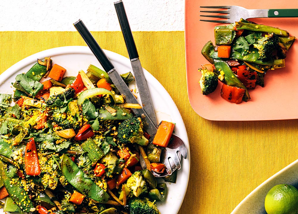 Plant-based diet shown to boost longevity for people with diabetes & heart disease: A veggie-laden stir-fry is served up on a large plate.