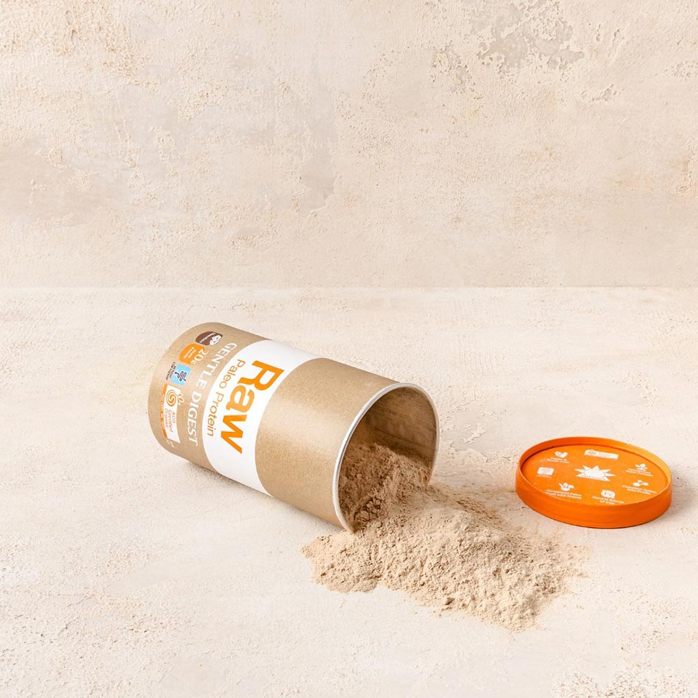 An image of a tub of Amazonia protein powder spilt out over a light coloured bench. 