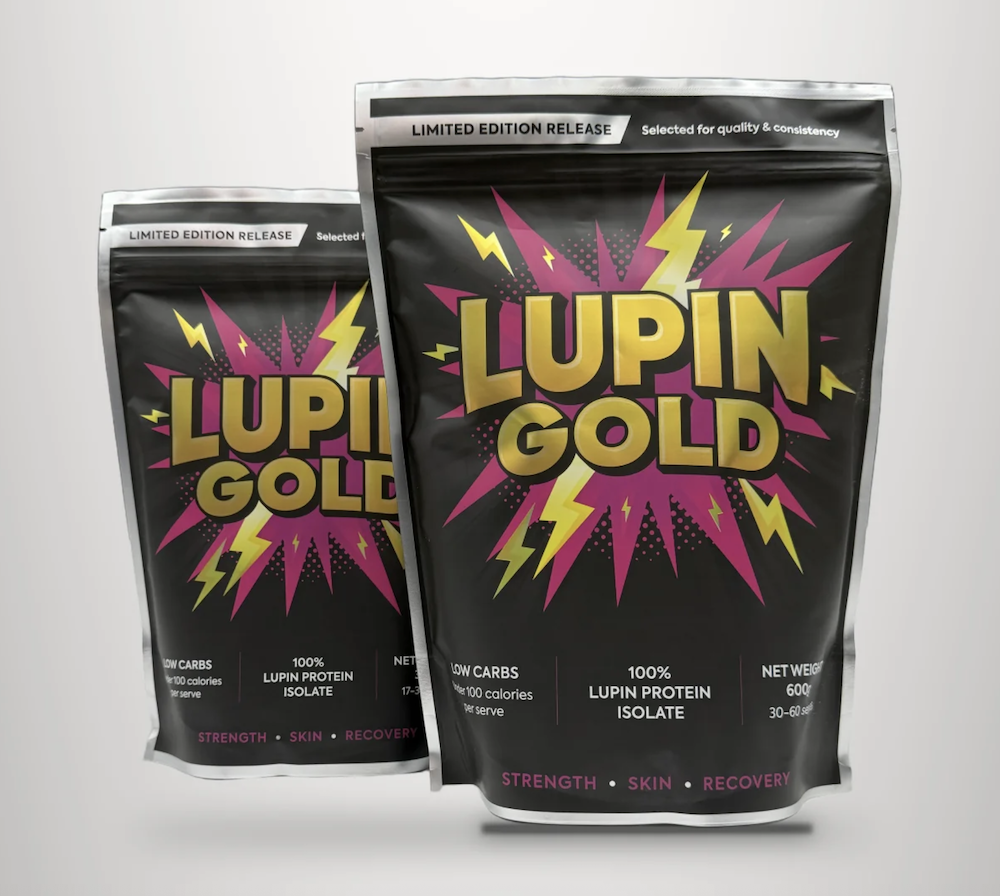 Two upright black pouches labelled Lupin Gold with a lightning bolt design. Features plant-based protein powder, low carbs, 100 calories, and Strength, Skin, Recovery listed at the bottom.